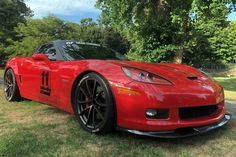 a red sports car parked in the grass