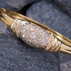 This fantastic hinged bangle bracelet has substantial weight and is crafted in high polished 18k yellow gold.  The center domed section of the bracelet is pavé set with a total of 1 carat of bright diamonds.  It fits up to a 6.25 inch wrist and is finished with a tongue and groove clasp with a figure eight safety.  One diamond is unnoticeably chipped. Yellow Gold Bangle With Pave Setting For Anniversary, Anniversary Yellow Gold Bangle With Pave Setting, Classic Yellow Gold Bangle With Pave Setting, Timeless Yellow Gold Bangle With Pave Setting, Luxury Hinged Yellow Gold Cuff Bracelet, Luxury Yellow Gold Sterling Silver Bangle Bracelet, Luxury Hinged Gold Bangle Bracelet, Luxury Yellow Gold Ornate Bangle, Antique Engagement Rings Sapphire