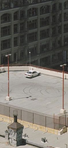 an empty parking lot in front of a large building