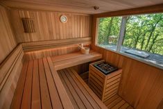 the inside of a wooden sauna with two benches and a cup on it's side