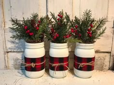 three white mason jars with red and black plaid decorations