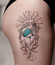 a woman with a tattoo on her thigh holding a globe