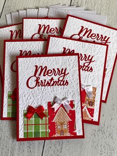 four christmas cards with red and green designs on them, one has a gingerbread house