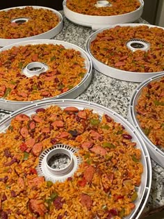 several trays filled with food sitting on top of a counter next to each other