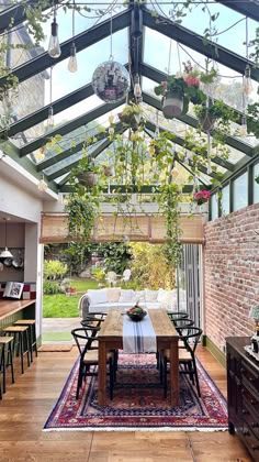 a dining room with a table and chairs under a glass roof