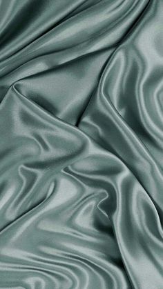 a close up view of a satin fabric with wavy lines in grey and white colors