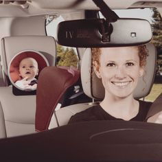 a woman sitting in the back seat of a car with a baby on her lap