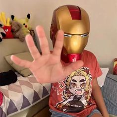 a person in a iron man shirt is holding up their hand to the camera with both hands