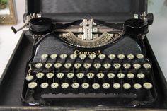 an old fashioned typewriter sitting on top of a table