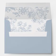 a blue and white envelope with flowers on the front, inside is folded in two separate sections