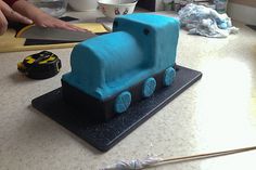 a cake shaped like a train sitting on top of a counter