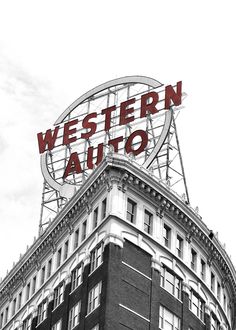 the western auto sign is on top of an old building