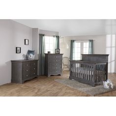 a baby crib and dresser in a room