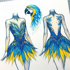 two blue and yellow dresses with an exotic bird on the back one is made out of feathers