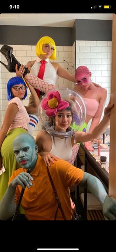 several people in costumes posing for a photo