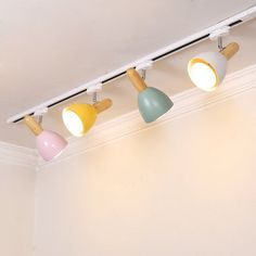 four lights are hanging from the ceiling in a room