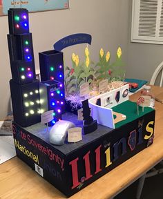 a table topped with lots of different types of plants and lights on top of it