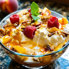 a glass bowl filled with fruit and yogurt