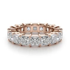 a rose gold wedding band with princess cut diamonds on the sides and four prongs