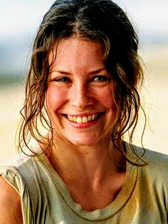 a woman with wet hair smiling at the camera