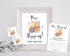 a baby shower sign and its name next to a frame on a table with flowers