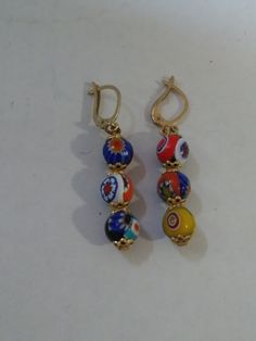 This is a really nice pair of millefiori round earrings. I reckon they are for pierced ears by their style. They dangle 1 1/2 with gold tone tops. Th Beads Earrings, Round Earrings, Pierced Ears, Round Beads, Ear Piercings, Beaded Earrings, Really Cool Stuff, Gold Tones, Drop Earrings