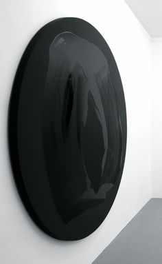 a black circular object hanging on the wall