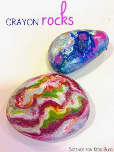 two colorful rocks sitting next to each other on a white surface with the words crayon rocks above them