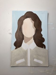 a painting of a woman's face on a white wall with brown hair and blue background