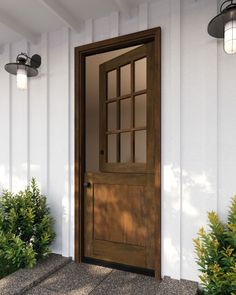 the front door to a white house with two lights on each side and one light on the other side