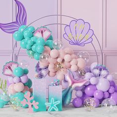 balloons and mermaid themed decorations on a table