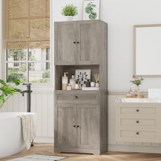 a bathroom with a wooden cabinet next to a bathtub