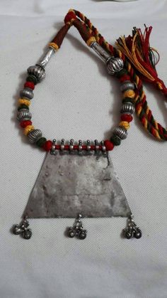 Vintage 1980s Handmade Rare Real Old High grade 80% Sterling silver Rajasthan Tribal banjara Artisan Pendant 26 inches longer adjustable New Cotton Multi Color Threaded Necklace Made By someone else. Discovered and collected by me. Primary Color of Pendant is vintage Silver, Pre- Owned Old looks. Weight of Necklace is 70 gms. Length of Pendant is 9 cm.with loop and dangles. Width of Pendant is 9.6 cm. It's a totally handmade Real old rajasthan tribal Necklace Traditional Silver Necklaces With Latkans, Traditional Metal Necklaces With Silver Beads, Bohemian Handmade Silver Temple Necklace, Handmade Bohemian Silver Temple Necklace, Vintage Silver Necklaces For Festivals, Ceremonial Silver Temple Necklace With Latkans, Silver Bohemian Temple Necklace For Festivals, Bohemian Silver Temple Necklace For Festival, Vintage Silver Jewelry For Festival