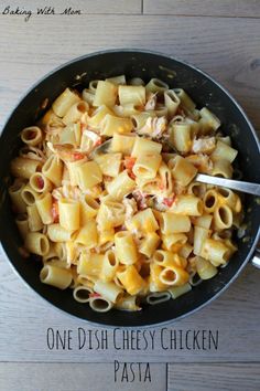 a pan filled with pasta on top of a wooden table