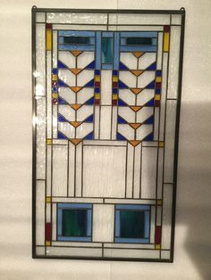 a stained glass window hanging on the wall