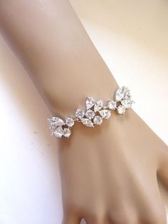 This elegant bracelet is made with the highest top quality clear cubic zirconia in a fancy shape consists of peardrop, marquise and round cubic zirconia in a white gold settings. The bracelet is closed off with tarnish resistant white gold plated brass clasp. All material used is white gold plated brass. Size: Length of the bracelet is 7 inches with a 2 inch extension chain  Matching Haircomb: https://www.etsy.com/au/listing/540921839/wedding-bridal-hair-comb-rose-gold Matching Earrings: https://www.etsy.com/au/listing/154214305/sales-bridal-earrings-high-quality-multi?ref=shop_home_active_10 Please read policy before committing to purchase: https://www.etsy.com/au/your/shops/JCBridalJewelry/policies Silver Cubic Zirconia Diamond Bracelet Pear-shaped, Pear-shaped Silver Bracelet For Weddings, White Marquise Bracelets For Wedding, White Marquise Bracelet For Wedding, Elegant Pear-shaped Bracelets For Wedding, Elegant Pear-shaped Bracelet For Wedding, Bracelet White Gold, Elegant Bracelet, Bridal Bracelet