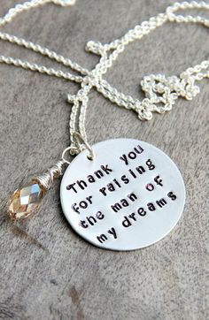 a necklace that says thank you for raising the man in my dreams