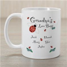 a white coffee mug with the words grandma's love bugs and ladybugs