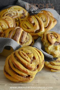 some cinnamon rolls sitting on top of a wooden table