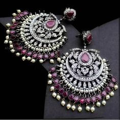 Adorn your beautiful personality with this exquisitely designed and handcrafted zirconia earrings lined with tiny pearls and studded with real AD stones . Pair them up with your silks and satins and shine like a glowing star at the next event!Earrings weight 60 gms Drop length 3 inches******************************************Product Care: Avoid spraying perfume or deodorant over Traditional jewelry. Exposure to humidity may cause darkening of chains and other metal elements. Avoid direct contac Elegant Jeweled Chandbali Pearl Earrings, Silver Chandbalis With Stone Work For Reception, Silver Jhumkas With Stone Work For Reception, Silver Bridal Earrings With Stone Work For Reception, Elegant Kundan Pearl Earrings With Stone Work, Elegant Kundan Bridal Earrings With Stone Work, Elegant Pearl Earrings With Stone Work For Wedding, Elegant Bridal Earrings With Stone Work In Cubic Zirconia, Silver Stone Work Earrings For Reception