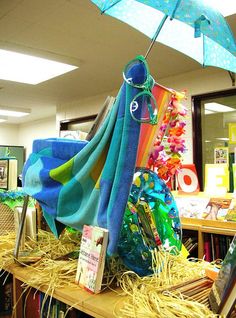 there is an umbrella and some books on the shelf in the library with it's blue cover