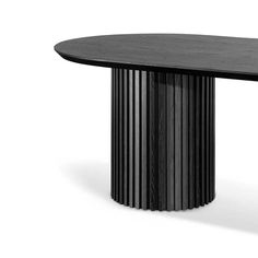 a black table with an oval shaped top and columns on the base, against a white background