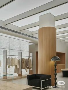 the interior of a clothing store with clothes on racks