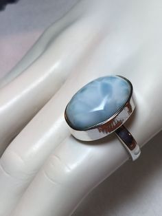 "Beautiful natural oval shape larimar stone sterling silver ring. This handmade ring arrives beautifully packaged in a gift box. Measurements: 22 mm x 12 mm Markings: 925  Larimar, or Stefilia's Stone, is a blue variety of pectolite found only in the Dominican Republic. \"Larimar is considered a healing stone. This ring is a size 8." Oval Blue Larimar Jewelry, Turquoise Larimar Ring As Gift, Turquoise Larimar Ring For Gift, Elegant Oval Larimar Rings, Turquoise Larimar Ring Gift, Oval Polished Moonstone Ring Gift, Larimar Turquoise Ring Gift, Larimar Turquoise Gemstone Ring For Anniversary, Larimar Turquoise Ring Gemstone Gift