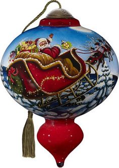 a glass ornament with santa riding in a sleigh