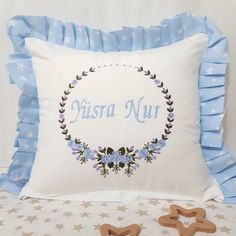 a decorative pillow with the word'tisra nur'in blue and white on it