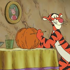 a cartoon character holding a pumpkin in front of a cat