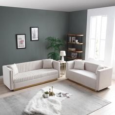 a living room with two white couches and a coffee table in front of it