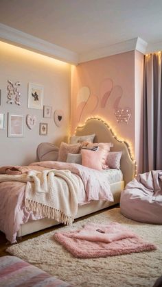 a bedroom decorated in pink and white with pictures on the wall