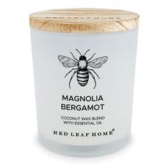 a jar of red leaf home's magnaolia bergamot candle is shown on a white background